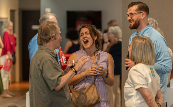 People laughing inside an art gallery 