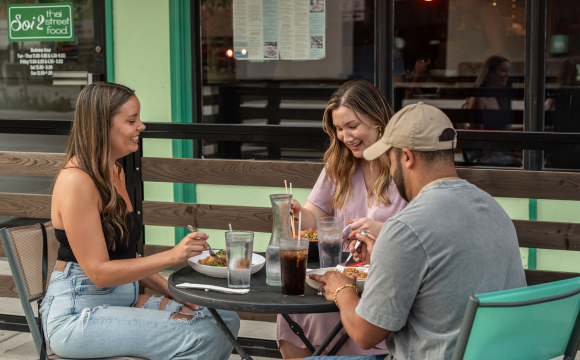 People enjoying food on the patio at Soi 2 Thai Street