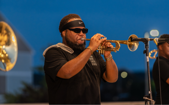 Man playing a horned instrument 