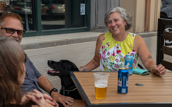 People enjoying a drink on the patio at Icon's martina