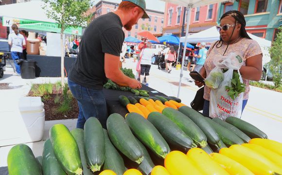 Vendor with customers at famers market
