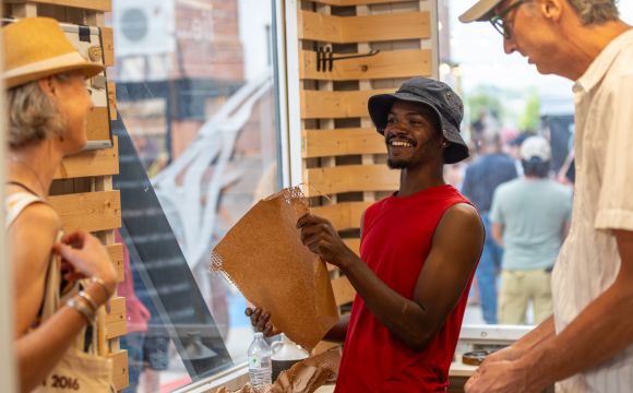 Merchant wrapping purchase in pop-up shop