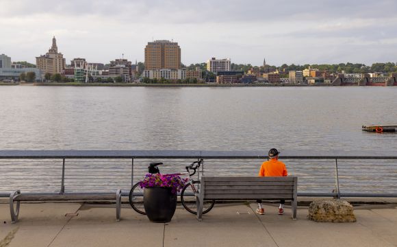 Biker taking a break on a park bench along the Mississippi River
