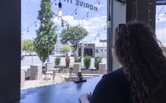 a lady looking out of a window at Awake