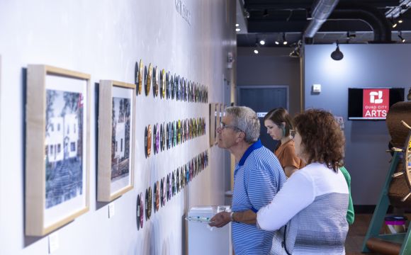 people looking at art in a gallery at QC Arts