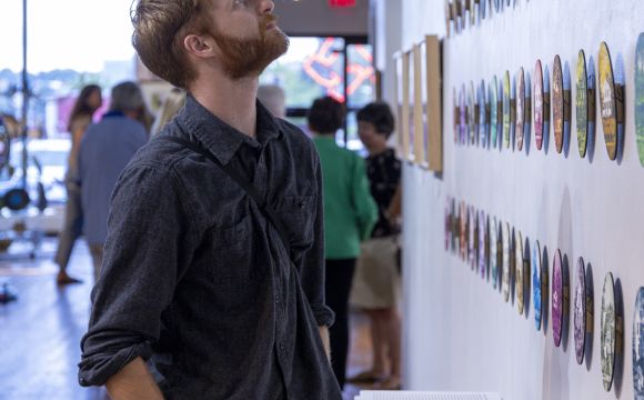 person looking at art at QC Arts