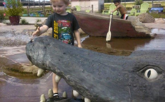kid playing in water feature at the Quad City Botanical Center