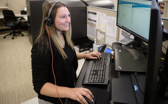 a professional working at their desk on a call at Modern Woodman