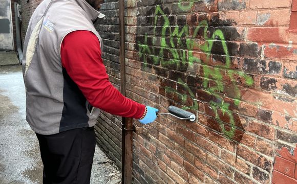 Ambassador removing graffiti
