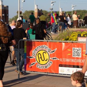 People Walk Towards a Music Stage