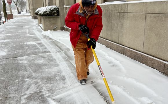 Ambassador shoveling snow