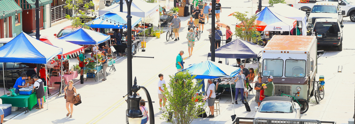 Ladies from Ballet Quad Cities dancing at an art fair with patrons